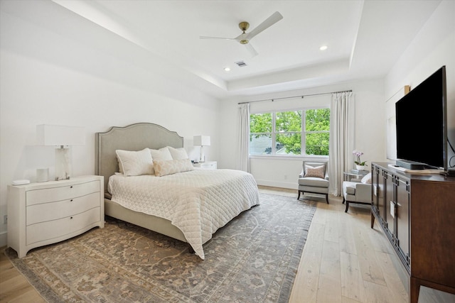 1505 Pine Chase Dr, Houston, TX 77055 - bedroom featuring light wood-type flooring, a tray ceiling, ceiling fan, recessed lighting, and baseboards