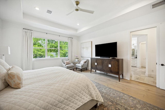1505 Pine Chase Dr, Houston, TX 77055 - bedroom with light wood-style flooring, a tray ceiling, recessed lighting, and a ceiling fan