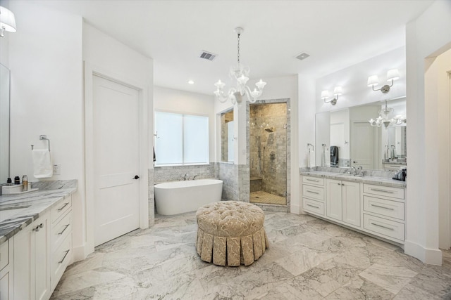 1505 Pine Chase Dr, Houston, TX 77055 - full bath featuring a chandelier, a stall shower, a freestanding bath, two vanities, and marble finish flooring