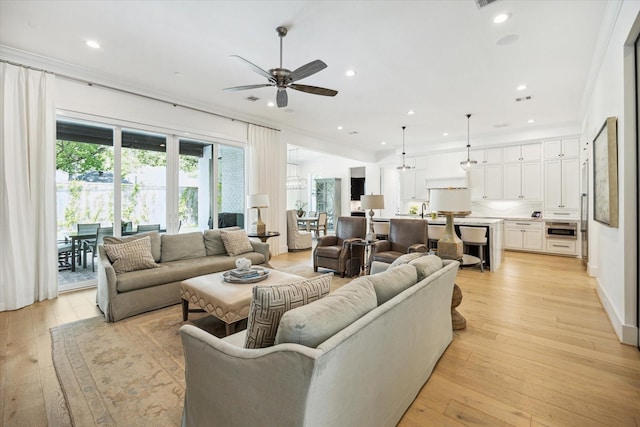 1505 Pine Chase Dr, Houston, TX 77055 - living room with ceiling fan, light wood-style flooring, recessed lighting, and ornamental molding