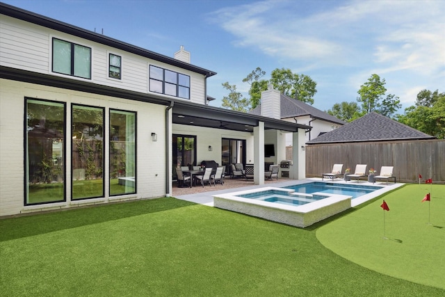 1505 Pine Chase Dr, Houston, TX 77055 - rear view of house with a chimney, a patio area, ceiling fan, a putting green, and brick siding
