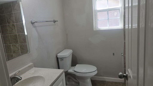 8607 Sherrywood Dr, Houston, TX 77044 - bathroom with vanity, toilet, tile patterned floors, and baseboards