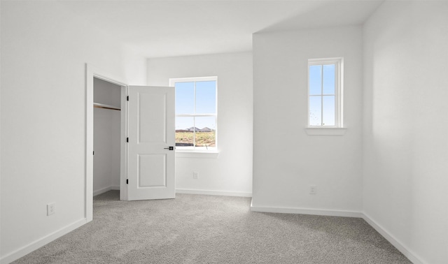 6220 Pelican Ridge Way, League City, TX 77573 - unfurnished bedroom with multiple windows, carpet, a spacious closet, and baseboards