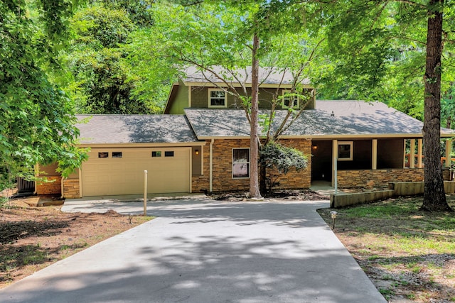 81 Baron Dr, Coldspring, TX 77331 - view of front of home featuring driveway, a garage, stone siding, and a shingled roof