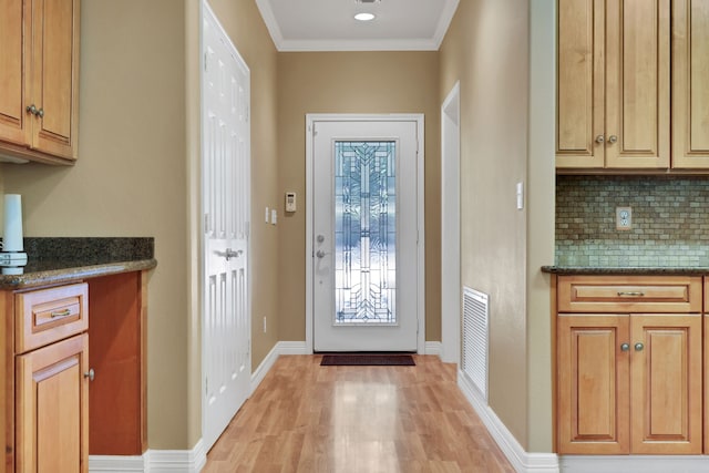 81 Baron Dr, Coldspring, TX 77331 - entryway with light wood finished floors, baseboards, and crown molding