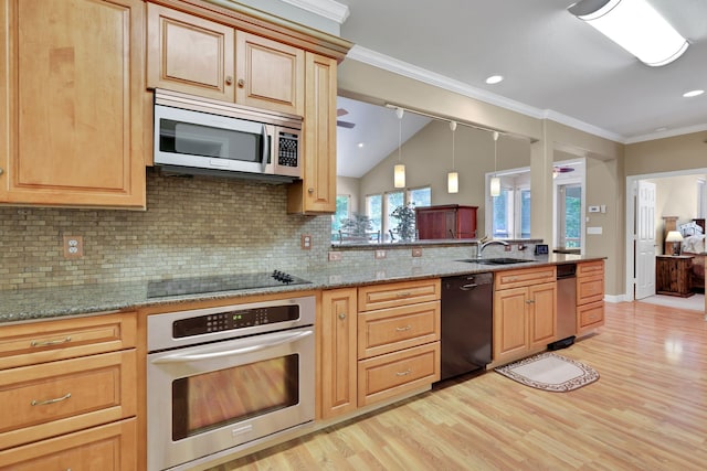 81 Baron Dr, Coldspring, TX 77331 - kitchen featuring black appliances, a sink, light wood-style floors, tasteful backsplash, and vaulted ceiling