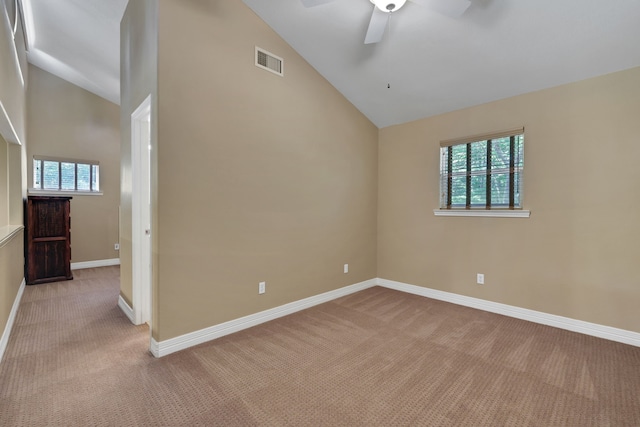 81 Baron Dr, Coldspring, TX 77331 - empty room featuring light carpet, plenty of natural light, a ceiling fan, baseboards, and high vaulted ceiling