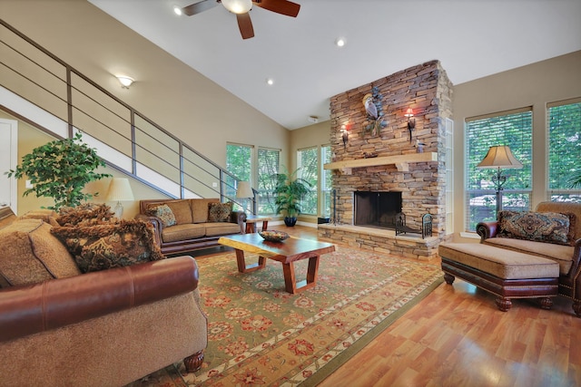 81 Baron Dr, Coldspring, TX 77331 - living area with high vaulted ceiling, wood finished floors, a ceiling fan, a stone fireplace, and recessed lighting