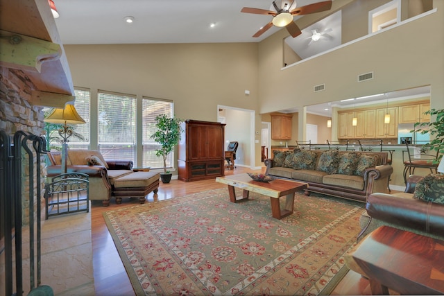 81 Baron Dr, Coldspring, TX 77331 - living room with high vaulted ceiling, ceiling fan, and light wood-style floors