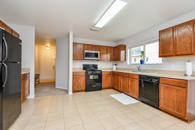 2739 Mustang Hill Ln, Katy, TX 77449 - kitchen with black appliances, a sink, light countertops, and brown cabinets