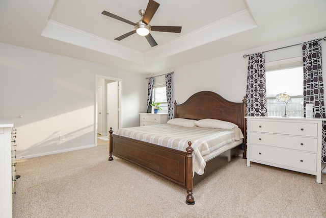 2739 Mustang Hill Ln, Katy, TX 77449 - bedroom featuring a tray ceiling, light carpet, crown molding, baseboards, and a ceiling fan