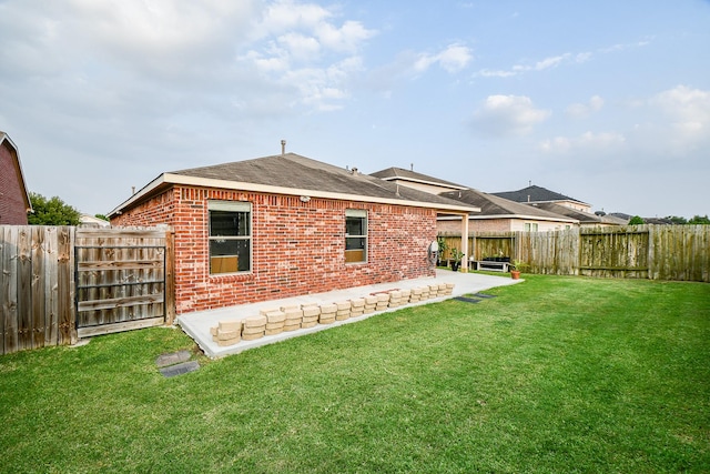 2739 Mustang Hill Ln, Katy, TX 77449 - back of property featuring brick siding, a patio area, and a shingled roof