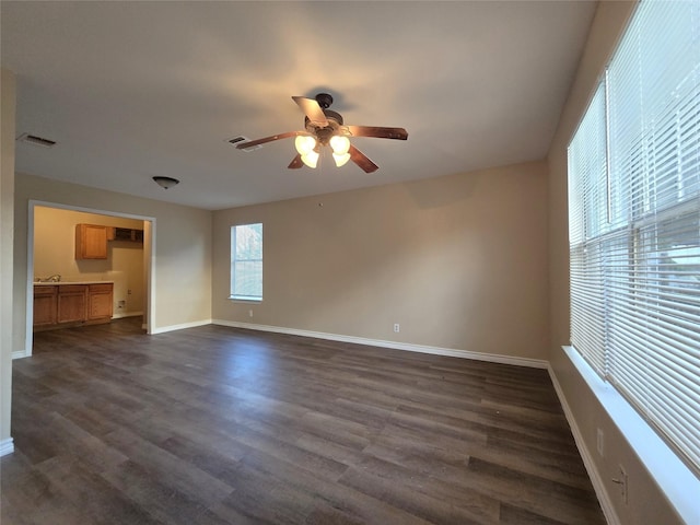 256 Alleda Rd, Prairie View, TX 77484 - unfurnished living room featuring ceiling fan, dark wood-type flooring, and baseboards