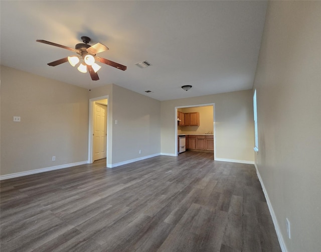 256 Alleda Rd, Prairie View, TX 77484 - unfurnished living room with a ceiling fan, dark wood-type flooring, and baseboards