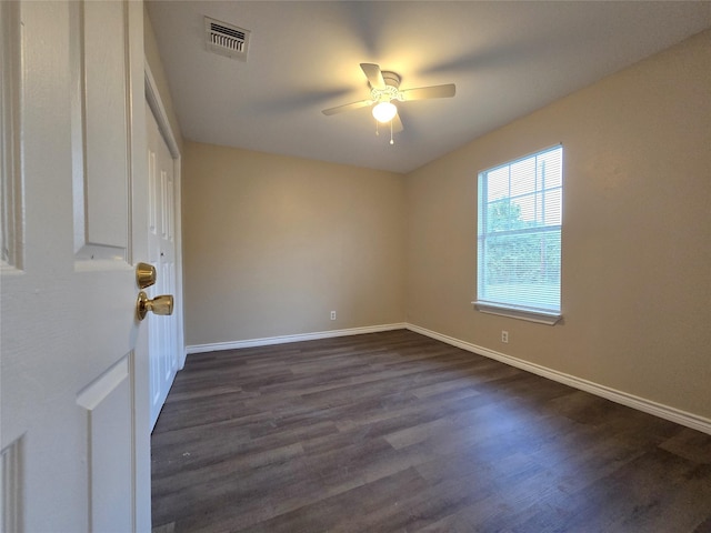 256 Alleda Rd, Prairie View, TX 77484 - spare room with dark wood-style floors, ceiling fan, and baseboards