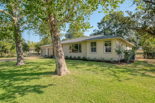 293 S College St, La Grange, TX 78945 - view of front of house featuring a front lawn and an attached garage