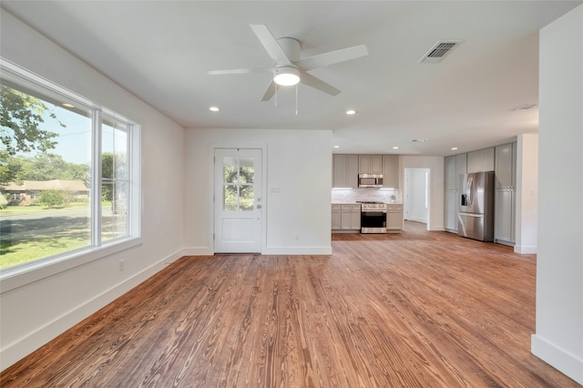 293 S College St, La Grange, TX 78945 - unfurnished living room with light wood-style flooring, baseboards, a ceiling fan, and recessed lighting