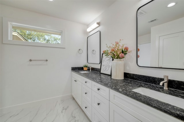 293 S College St, La Grange, TX 78945 - bathroom featuring marble finish floors, double vanity, baseboards, and recessed lighting
