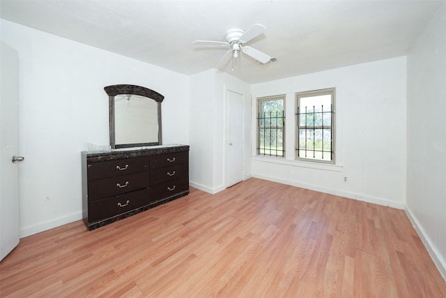 7013 Kittridge St, Houston, TX 77028 - unfurnished bedroom with light wood-style flooring, baseboards, and a ceiling fan