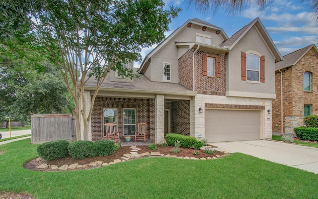 13219 Riata River Ln, Humble, TX 77346 - view of front facade with concrete driveway, stucco siding, an attached garage, a front lawn, and stone siding