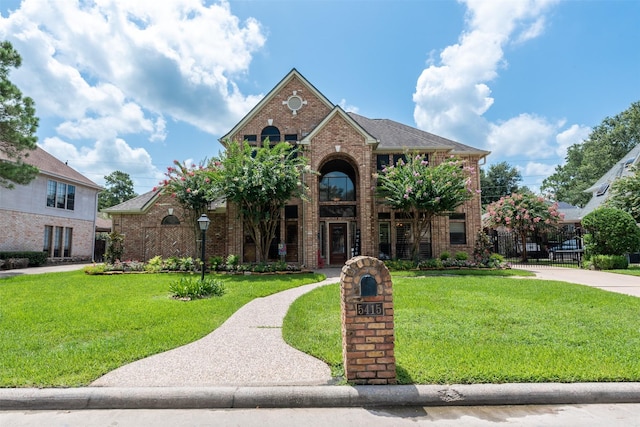 5415 Winding Ridge Dr, Spring, TX 77379 - traditional-style home featuring brick siding and a front lawn
