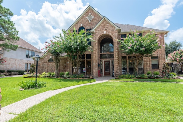 5415 Winding Ridge Dr, Spring, TX 77379 - traditional-style house featuring brick siding and a front lawn