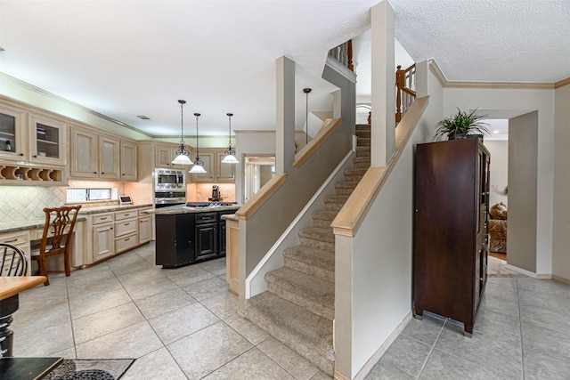 5415 Winding Ridge Dr, Spring, TX 77379 - kitchen featuring stainless steel appliances, crown molding, a kitchen island, light countertops, and tasteful backsplash
