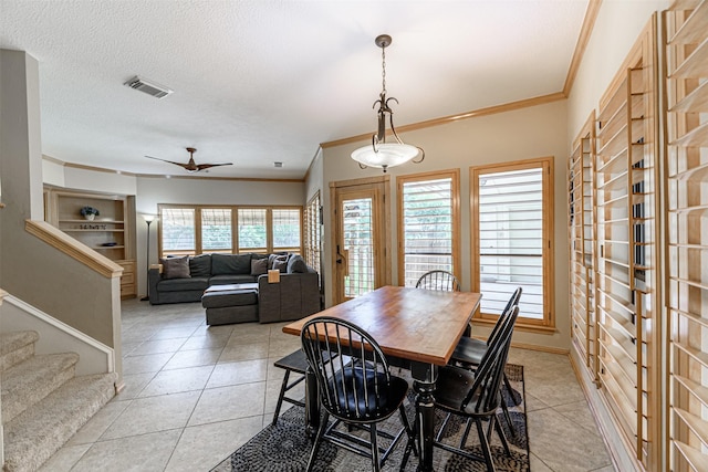 5415 Winding Ridge Dr, Spring, TX 77379 - dining area with crown molding, light tile patterned flooring, a ceiling fan, stairway, and a textured ceiling