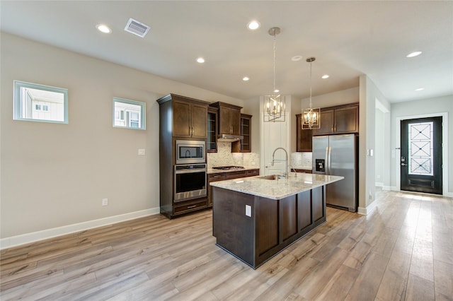 4209 Colony Pines Ln, Houston, TX 77080 - kitchen featuring appliances with stainless steel finishes, a sink, a chandelier, dark brown cabinets, and recessed lighting