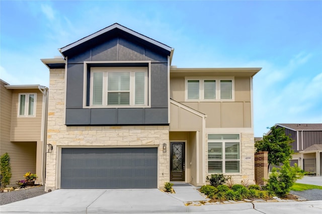 4209 Colony Pines Ln, Houston, TX 77080 - view of front of house featuring stone siding, an attached garage, driveway, and stucco siding