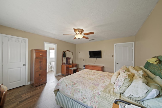 5111 Halbert Dr, Pearland, TX 77581 - bedroom with wood finished floors, a textured ceiling, ceiling fan, baseboards, and ensuite bath