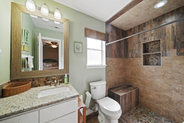 5111 Halbert Dr, Pearland, TX 77581 - full bath with vanity, toilet, a tile shower, a ceiling fan, and baseboards