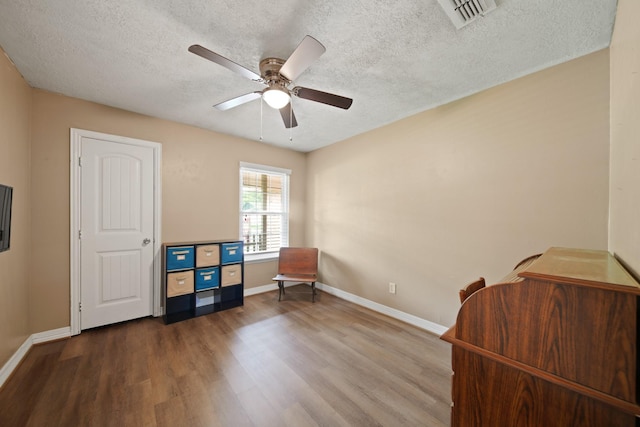5111 Halbert Dr, Pearland, TX 77581 - sitting room with wood finished floors, a textured ceiling, baseboards, and ceiling fan