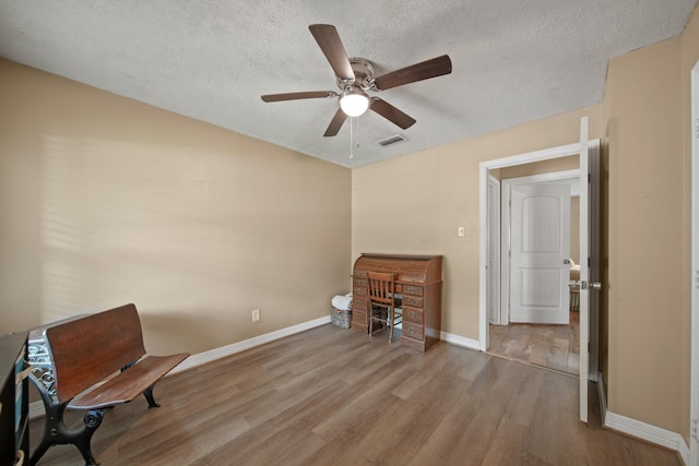 5111 Halbert Dr, Pearland, TX 77581 - living area with baseboards, wood finished floors, ceiling fan, and a textured ceiling