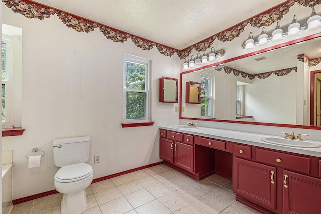 18751 Julie Ln, Magnolia, TX 77355 - bathroom with double vanity, a garden tub, toilet, a textured ceiling, and tile patterned flooring