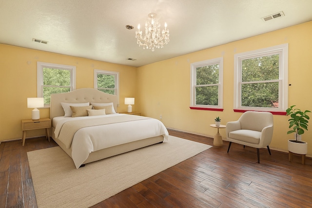 18751 Julie Ln, Magnolia, TX 77355 - bedroom with dark wood-style floors and a chandelier
