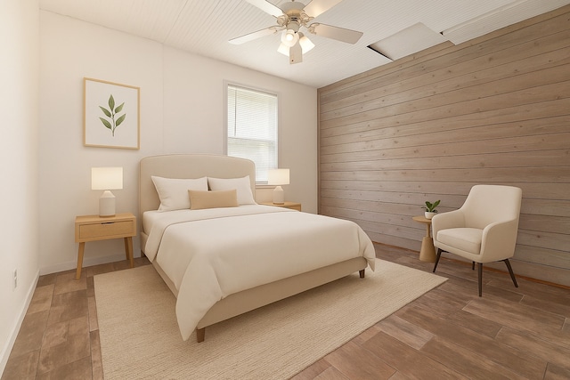 18751 Julie Ln, Magnolia, TX 77355 - bedroom featuring wood walls, a ceiling fan, and light wood-style floors