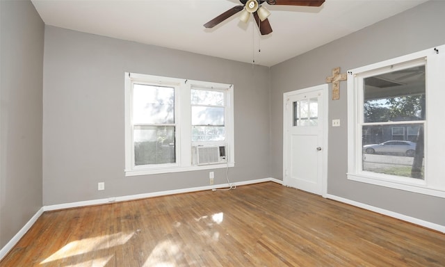 4915 Walker St, Houston, TX 77023 - spare room with baseboards, plenty of natural light, wood finished floors, and a ceiling fan