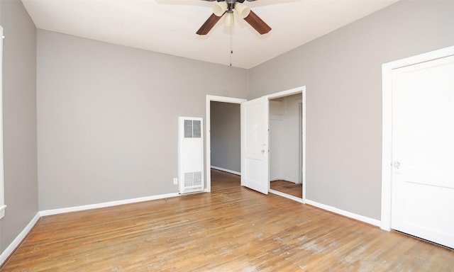 4915 Walker St, Houston, TX 77023 - unfurnished bedroom featuring a heating unit, light wood-style floors, baseboards, and ceiling fan