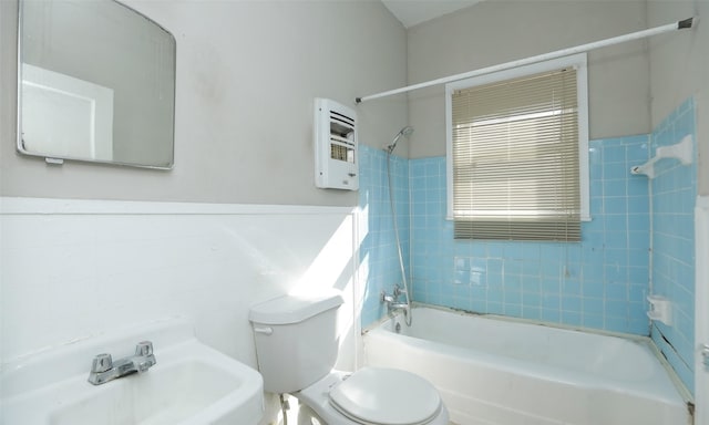4915 Walker St, Houston, TX 77023 - full bathroom featuring toilet, shower / bathtub combination, a sink, heating unit, and wainscoting