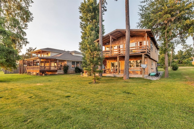 784 W Cattle Dr, Onalaska, TX 77360 - rear view of house with a wooden deck, a lawn, and a patio