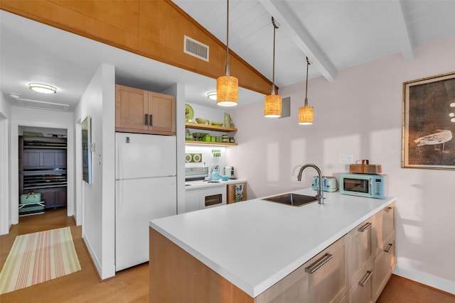 784 W Cattle Dr, Onalaska, TX 77360 - kitchen with white appliances, a sink, a peninsula, open shelves, and baseboards