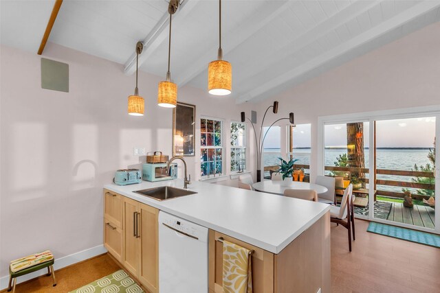 784 W Cattle Dr, Onalaska, TX 77360 - kitchen with white dishwasher, a sink, a peninsula, light brown cabinets, and light countertops