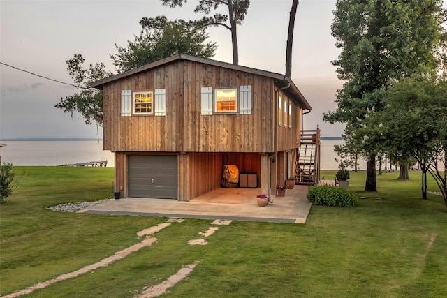 784 W Cattle Dr, Onalaska, TX 77360 - back of house featuring a lawn, stairs, and a water view