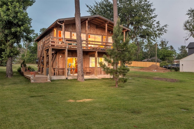 784 W Cattle Dr, Onalaska, TX 77360 - rear view of house featuring a deck and a lawn