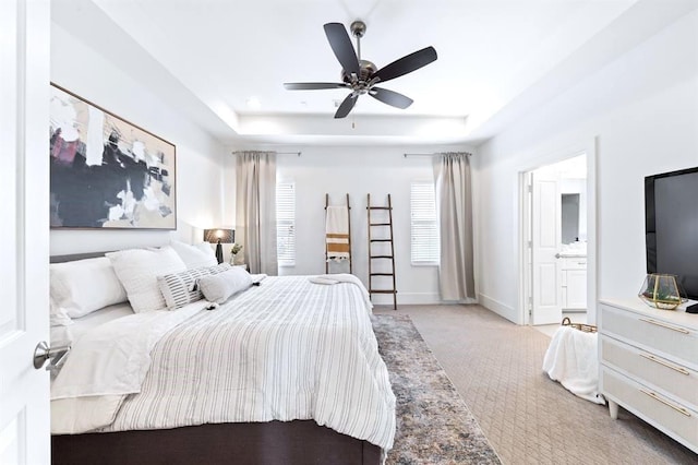 1822 Mcilhenny St Unit B, Houston, TX 77004 - carpeted bedroom featuring a raised ceiling, baseboards, connected bathroom, and ceiling fan