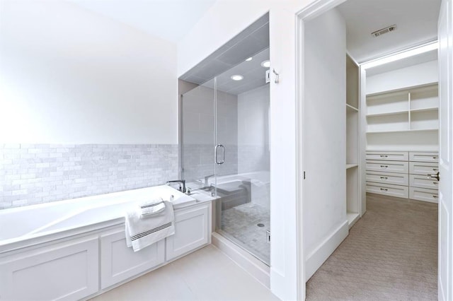 1822 Mcilhenny St Unit B, Houston, TX 77004 - full bathroom with a bath, a stall shower, and a walk in closet