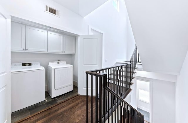1822 Mcilhenny St Unit B, Houston, TX 77004 - washroom featuring separate washer and dryer, cabinet space, and dark wood finished floors