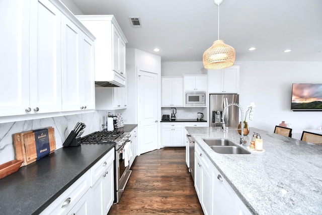 1822 Mcilhenny St Unit B, Houston, TX 77004 - kitchen featuring appliances with stainless steel finishes, a sink, white cabinetry, pendant lighting, and recessed lighting