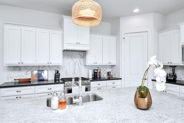 1822 Mcilhenny St Unit B, Houston, TX 77004 - kitchen with stainless steel stove, white cabinets, tasteful backsplash, pendant lighting, and recessed lighting